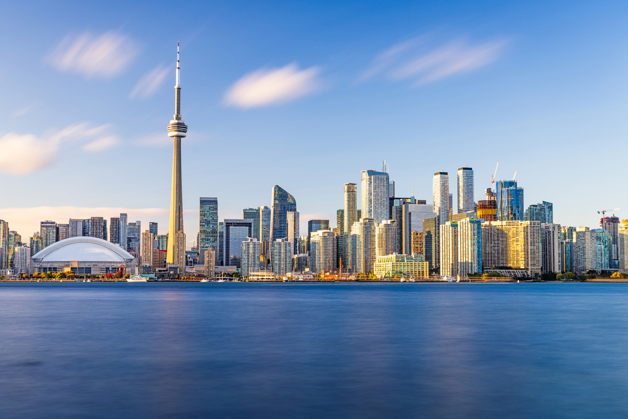 Toronto skyline glowing at dusk, a vibrant snapshot of urban life in Canada.