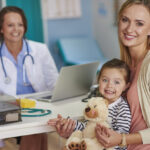 Child at a medical appointment, receiving care through the UK healthcare system.