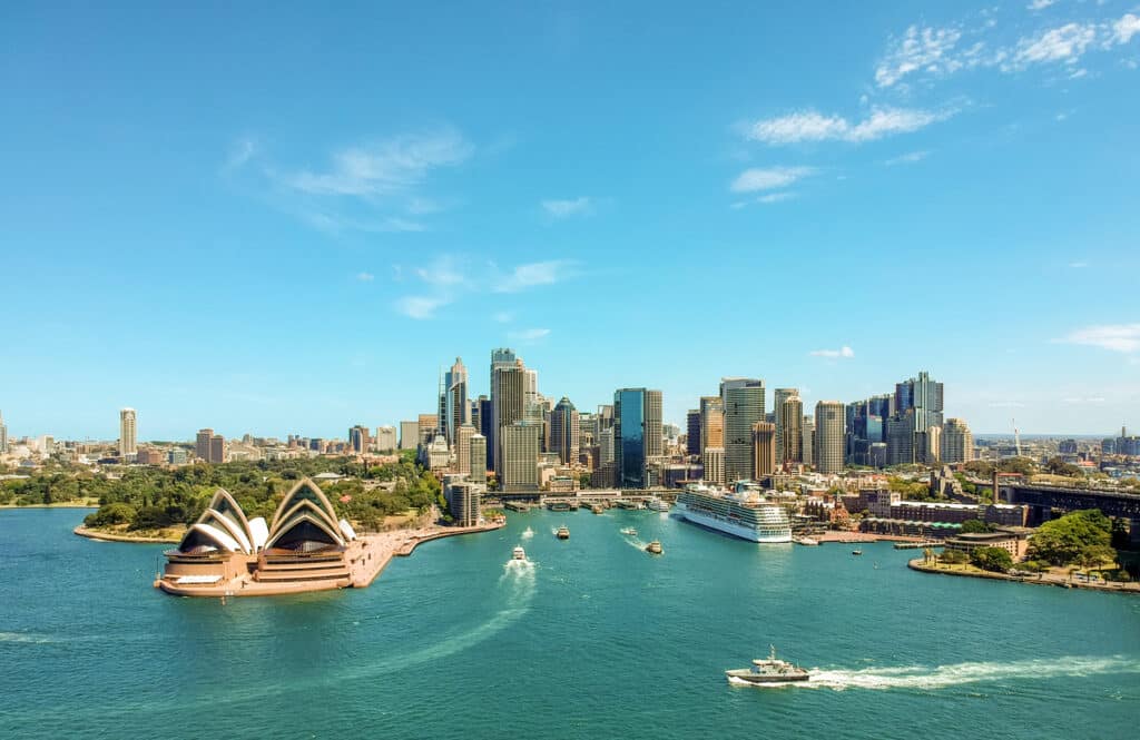 Opera House and skyscrapers in view, showcasing luxury real estate Australia.