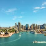 Opera House and skyscrapers in view, showcasing luxury real estate Australia.