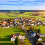 Aerial view of a Bavarian village, reflecting the peaceful countryside lifestyle many consider when buying a house in Germany.