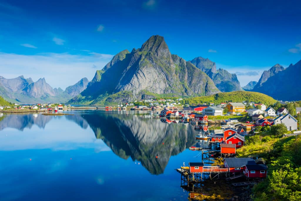 Perfect reflection of Reine village in the Lofoten Islands, showcasing the dramatic scenery enjoyed by Americans living in Norway.
