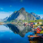 Perfect reflection of Reine village in the Lofoten Islands, showcasing the dramatic scenery enjoyed by Americans living in Norway.