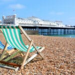 Sun loungers lined up on Brighton beach, evoking the relaxed seaside lifestyle many people consider when researching the best places to retire in the UK.