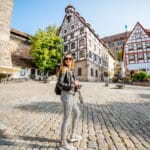 Young woman exploring Nuremberg’s old town, capturing a glimpse of daily life while living in Germany as an American.