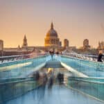 Sunset view of Millennium Bridge and St Paul’s Cathedral in London, representing the destination many professionals move to on a UK work permit visa.