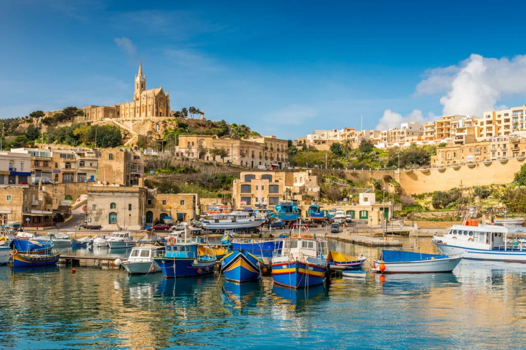 Coastal view of Gozo in the Maltese archipelago, setting the scene for the cross-border pension issues involved in Malta QROPS tax reporting.
