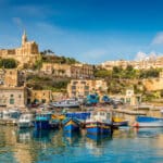 Coastal view of Gozo in the Maltese archipelago, setting the scene for the cross-border pension issues involved in Malta QROPS tax reporting.