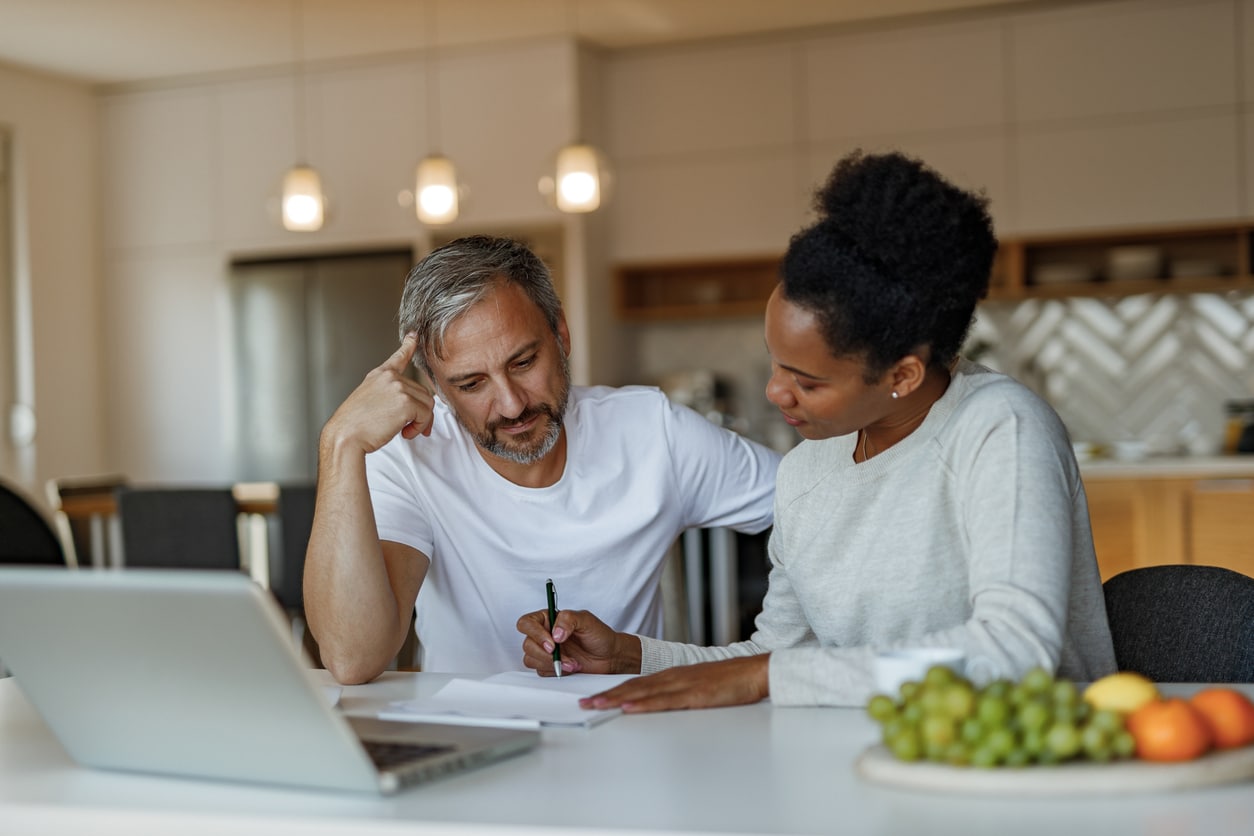 Two colleagues reviewing financial work together, reflecting the kind of planning needed to avoid an IRA early withdrawal penalty.